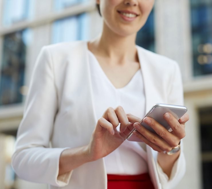 businesswoman-using-smartphone-outdoors-cropped-KAYU7S3.jpg