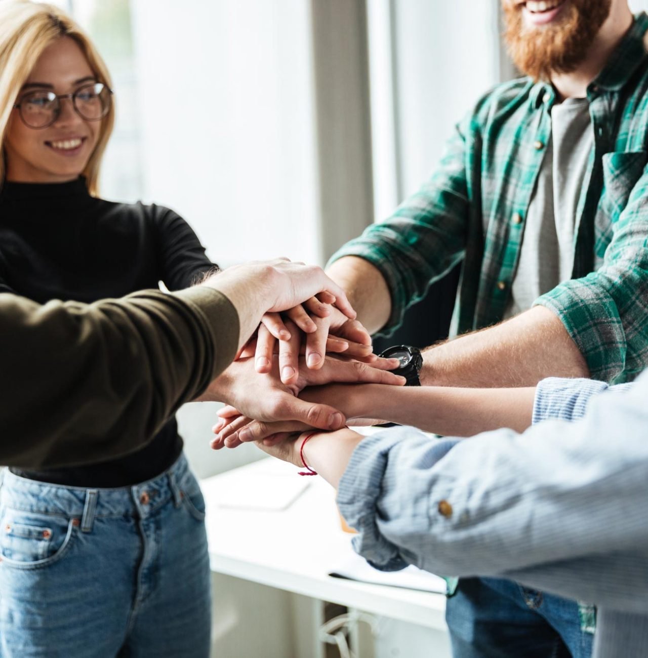 colleagues-in-office-holding-hands-of-each-other-PWVQD3F.jpg